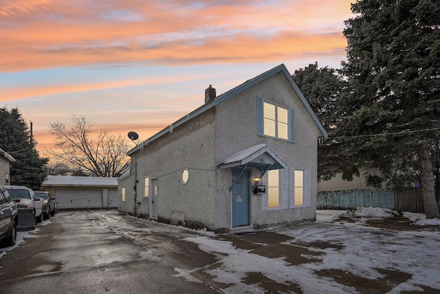 view of front of house with an outdoor structure and a garage