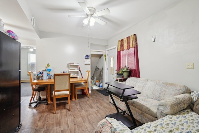 living room with ceiling fan and light wood-type flooring