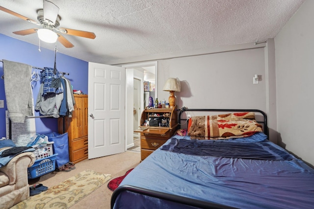 bedroom with carpet flooring, ceiling fan, and a textured ceiling