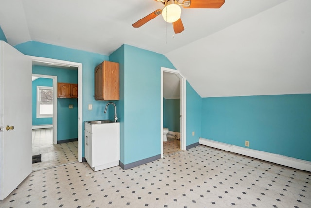 kitchen with baseboard heating, ceiling fan, sink, and lofted ceiling