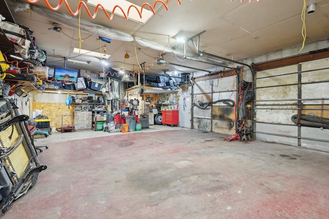 garage featuring a workshop area and a garage door opener