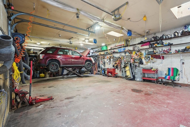 garage with a workshop area and a garage door opener