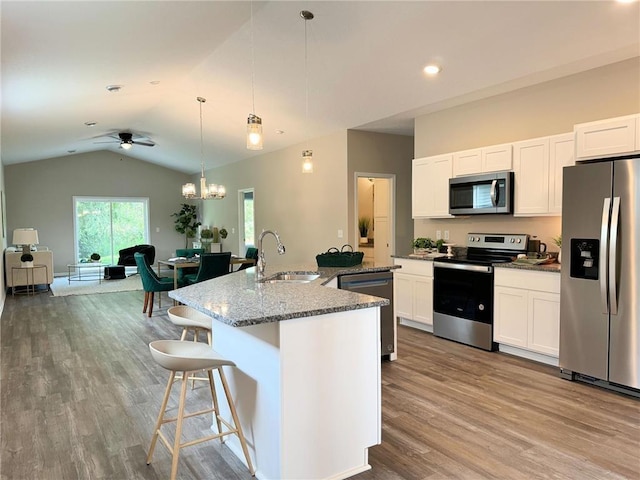 kitchen featuring pendant lighting, a kitchen island with sink, ceiling fan with notable chandelier, sink, and stainless steel appliances