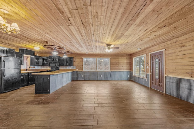 kitchen featuring black appliances, wood counters, wooden ceiling, and wooden walls