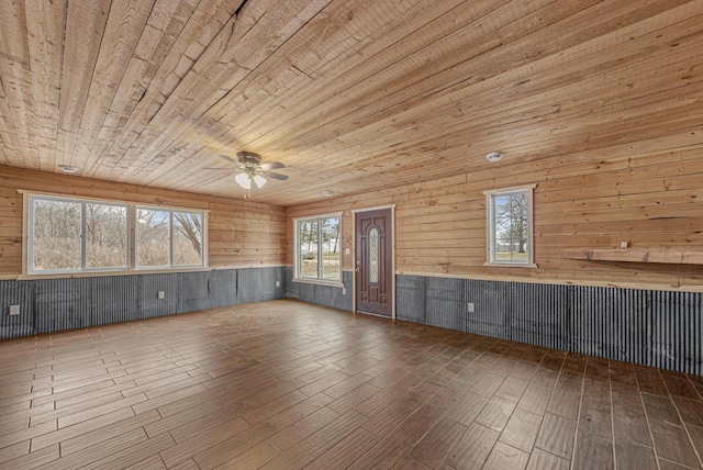 interior space featuring wood walls, a healthy amount of sunlight, wood ceiling, and hardwood / wood-style floors