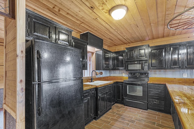 kitchen with sink, dark wood-type flooring, wooden ceiling, butcher block countertops, and black appliances