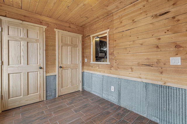 interior space with wood walls and dark hardwood / wood-style flooring