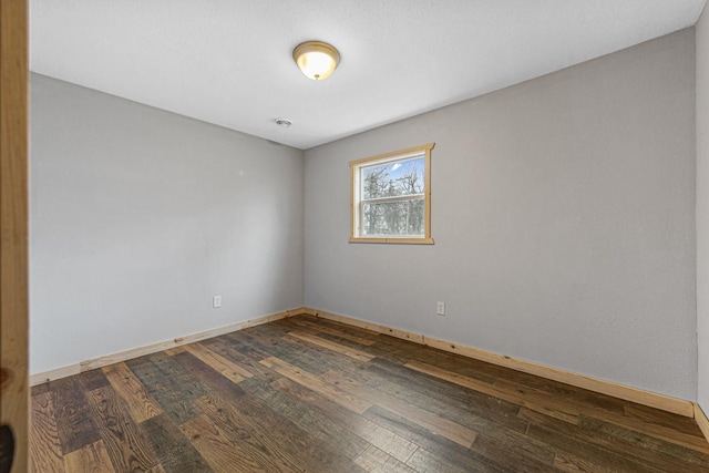 unfurnished room with hardwood / wood-style flooring