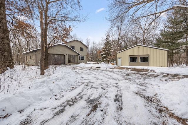 yard layered in snow featuring a garage