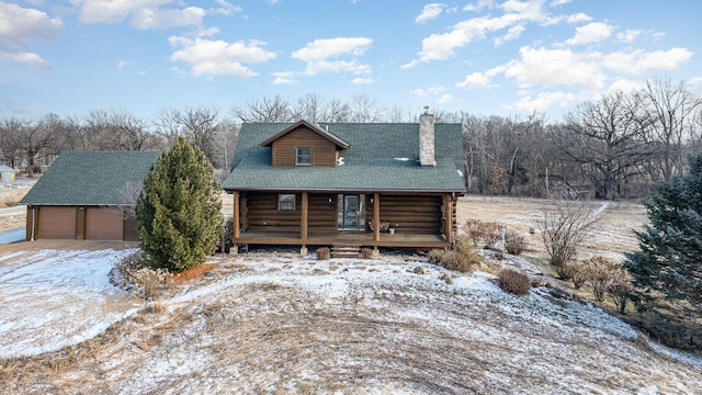 cabin featuring an outbuilding and a garage