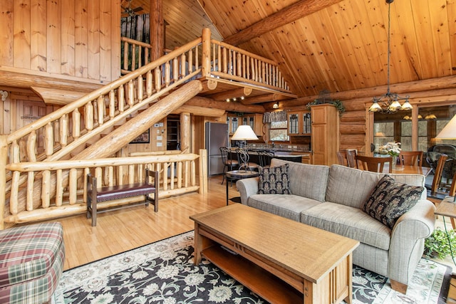 living room featuring wooden ceiling, beamed ceiling, high vaulted ceiling, a chandelier, and light hardwood / wood-style floors