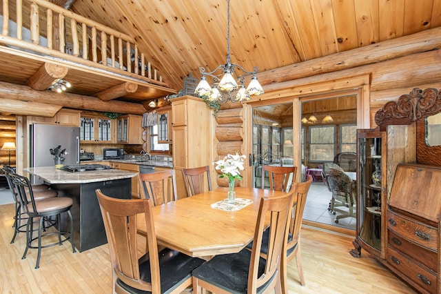 dining space with rustic walls, a chandelier, light hardwood / wood-style flooring, and wooden ceiling