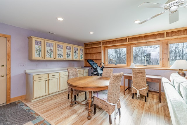 dining room with light hardwood / wood-style flooring and ceiling fan