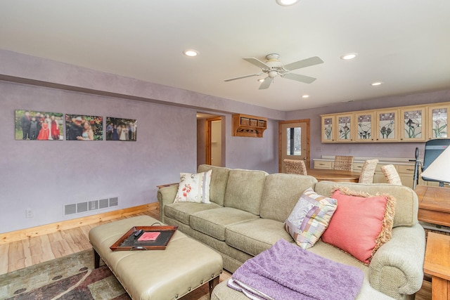 living room with ceiling fan and hardwood / wood-style flooring