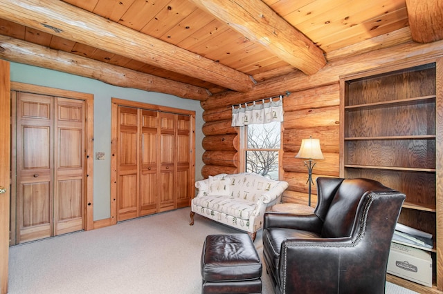 sitting room with beamed ceiling, carpet, wooden ceiling, and log walls