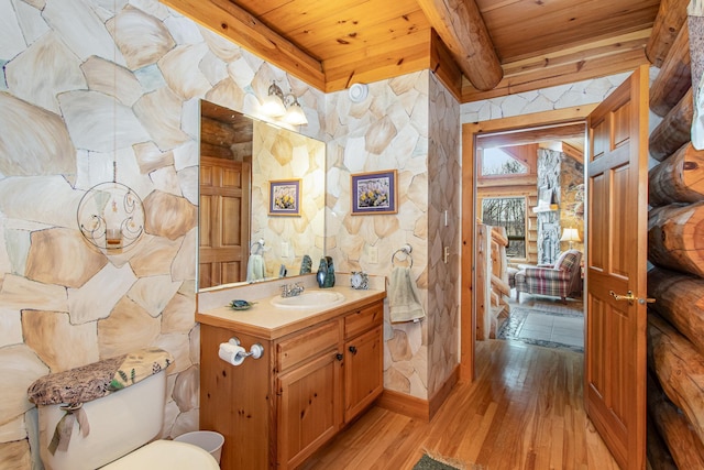 bathroom featuring hardwood / wood-style floors, vanity, wooden ceiling, and beamed ceiling