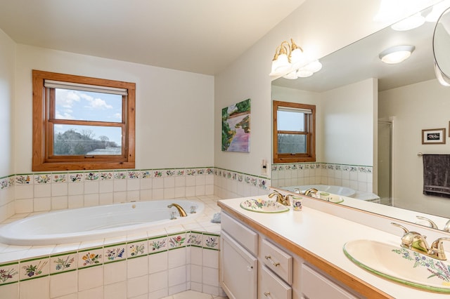 bathroom featuring vanity, walk in shower, and a wealth of natural light