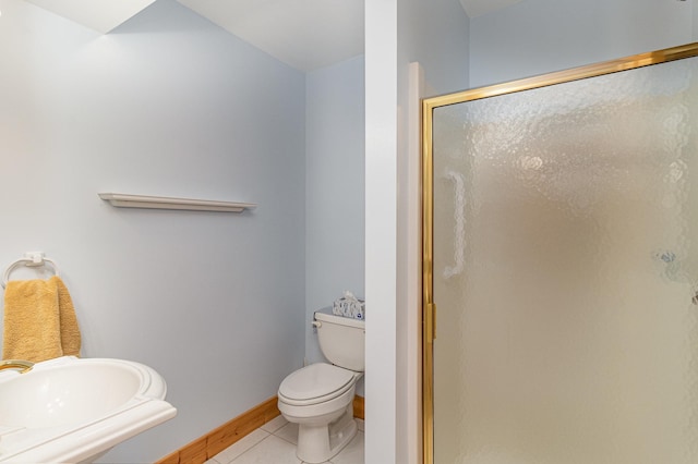 bathroom with tile patterned floors, toilet, sink, and walk in shower