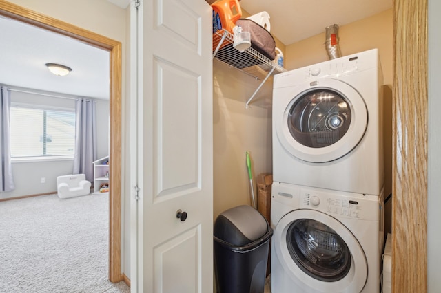 laundry room with stacked washer and clothes dryer and carpet