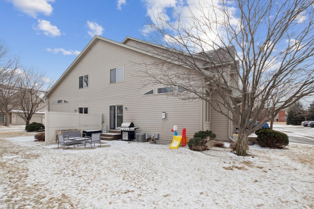 snow covered property with cooling unit