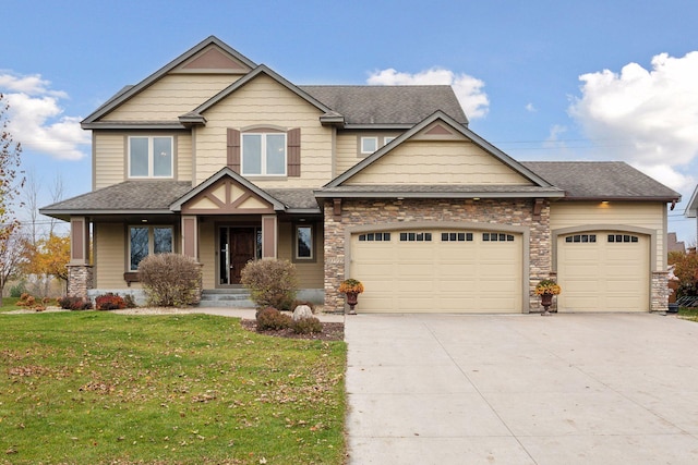 craftsman house with a front yard and a garage