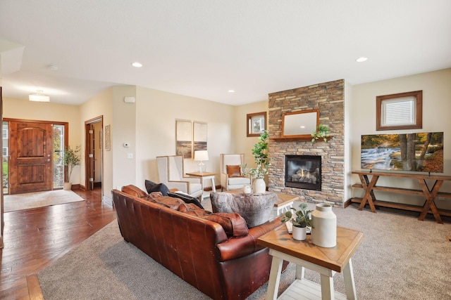 living room with dark hardwood / wood-style flooring and a fireplace