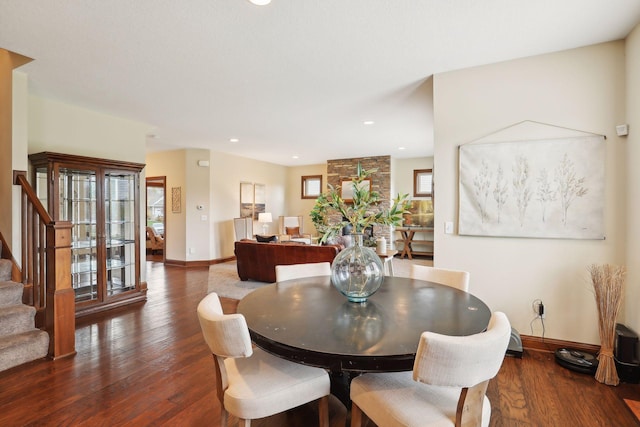 dining area with plenty of natural light and dark hardwood / wood-style flooring