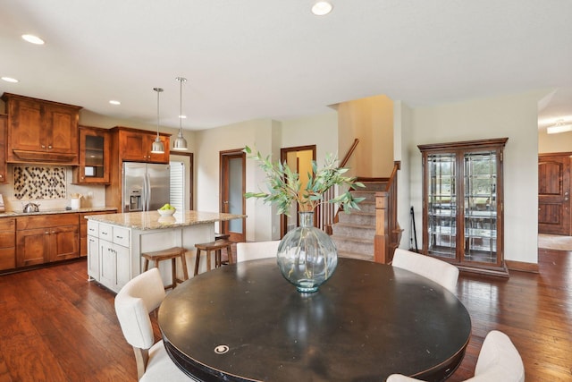 dining area with dark hardwood / wood-style floors and sink