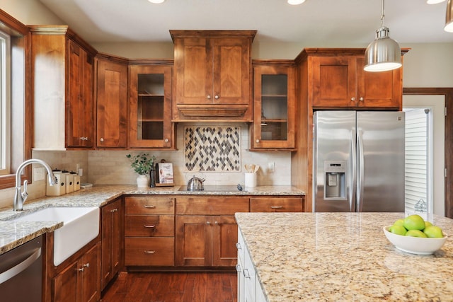 kitchen featuring light stone counters, sink, dark hardwood / wood-style floors, and appliances with stainless steel finishes