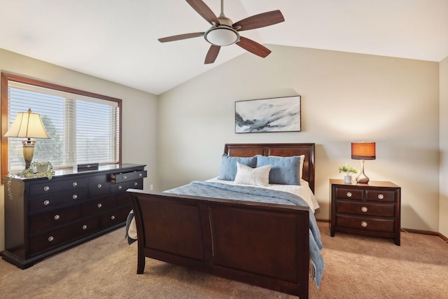 carpeted bedroom with ceiling fan and vaulted ceiling