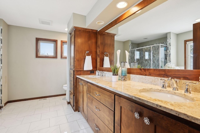 bathroom with tile patterned floors, vanity, toilet, and an enclosed shower