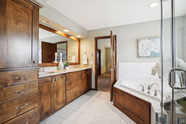 bathroom with tile patterned flooring, vanity, and a tub