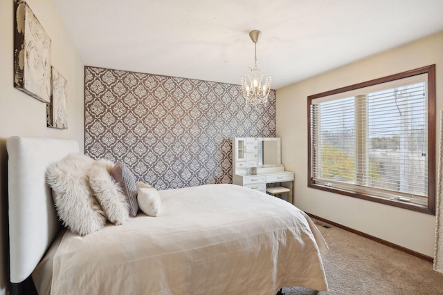 bedroom featuring carpet and a chandelier