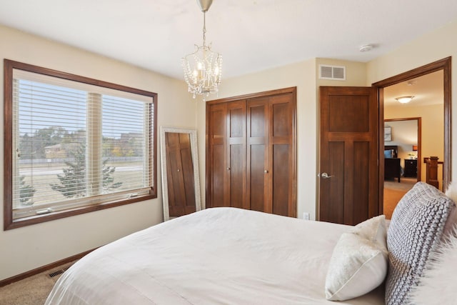 bedroom with light carpet and an inviting chandelier