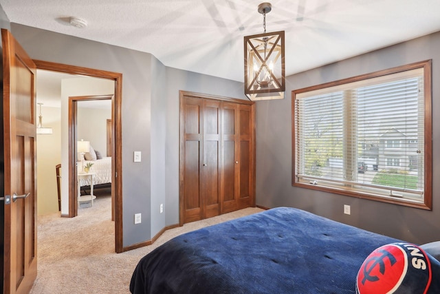 carpeted bedroom featuring a closet and a textured ceiling