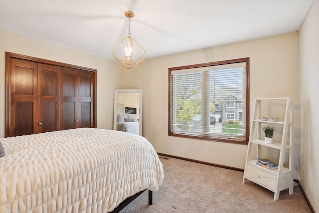 carpeted bedroom with a chandelier