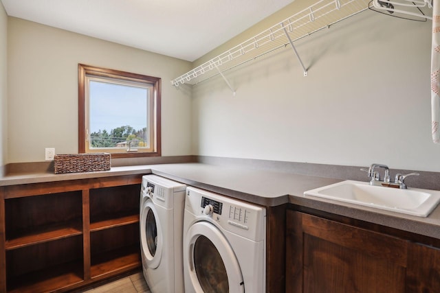 clothes washing area featuring separate washer and dryer, sink, and light tile patterned floors