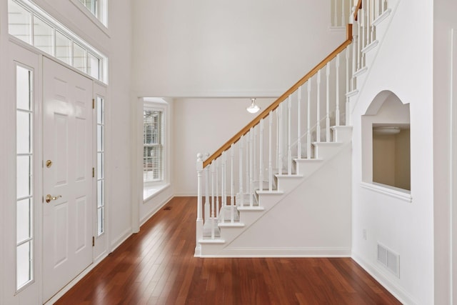 foyer with dark wood-type flooring and a high ceiling