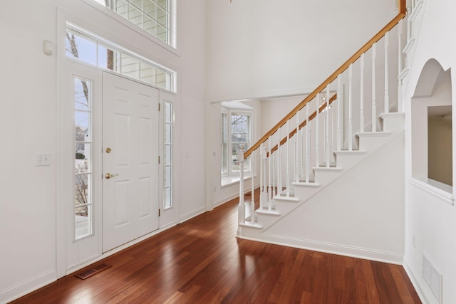 entrance foyer with a high ceiling and dark hardwood / wood-style flooring