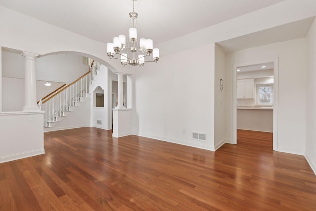 unfurnished dining area featuring hardwood / wood-style flooring and an inviting chandelier