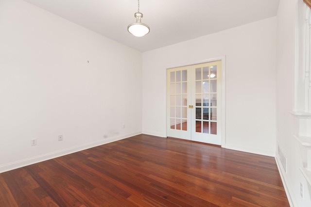 empty room with french doors and dark hardwood / wood-style flooring