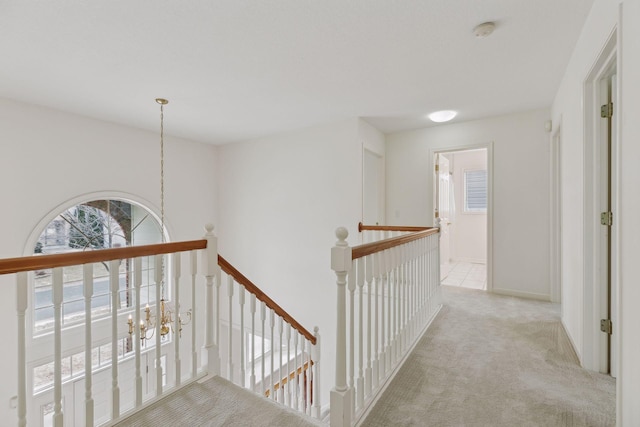 hallway featuring light colored carpet