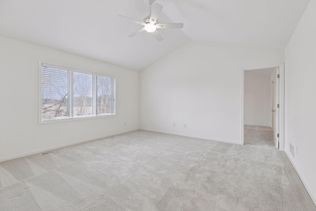 carpeted empty room featuring ceiling fan and vaulted ceiling