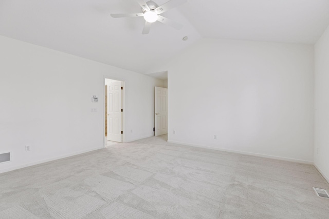 carpeted empty room featuring vaulted ceiling and ceiling fan