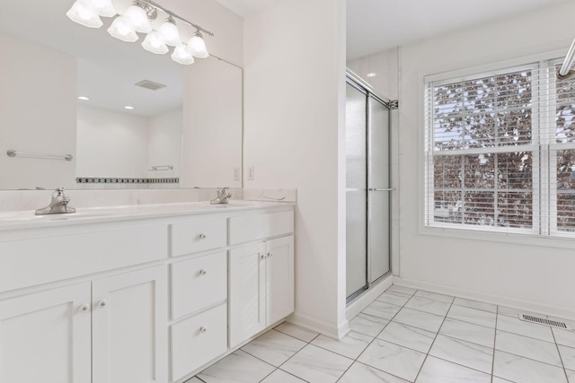 bathroom with plenty of natural light, vanity, and walk in shower