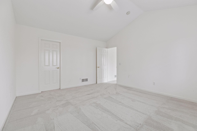 spare room with ceiling fan, light carpet, and high vaulted ceiling