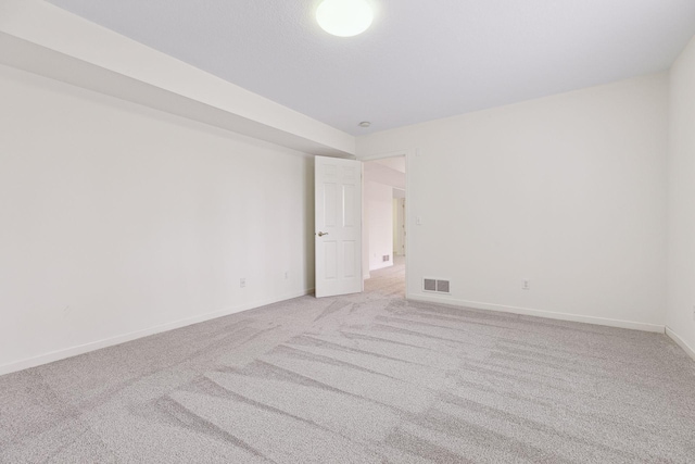 unfurnished room featuring light colored carpet