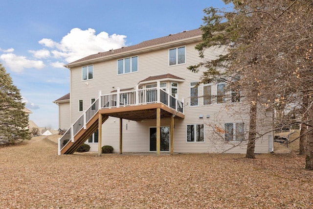 rear view of property featuring a wooden deck