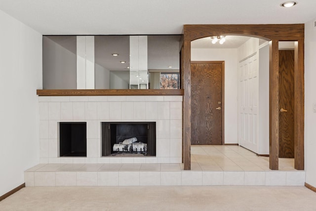 interior details with carpet floors and a tile fireplace