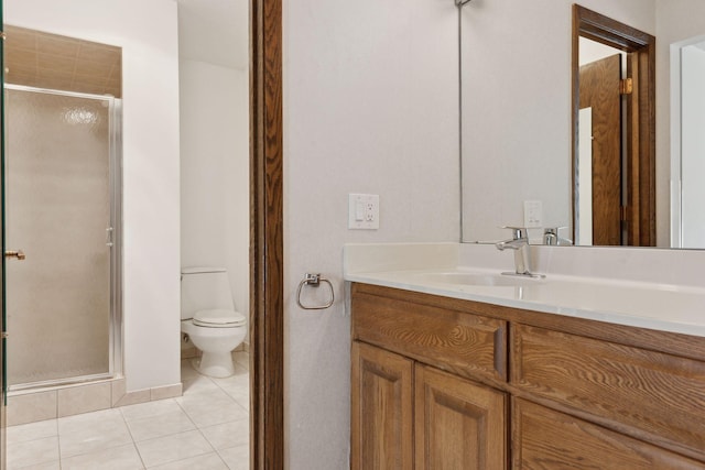 bathroom featuring tile patterned flooring, vanity, toilet, and an enclosed shower